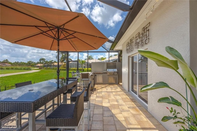 13461 Bridgeford Ave, Bonita Springs, FL 34135 - view of patio / terrace with an outdoor kitchen and outdoor dining space