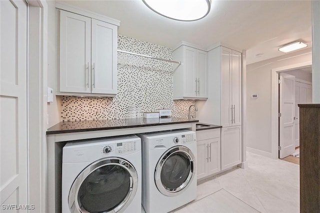 13461 Bridgeford Ave, Bonita Springs, FL 34135 - washroom featuring washing machine and dryer, cabinet space, and light tile patterned floors