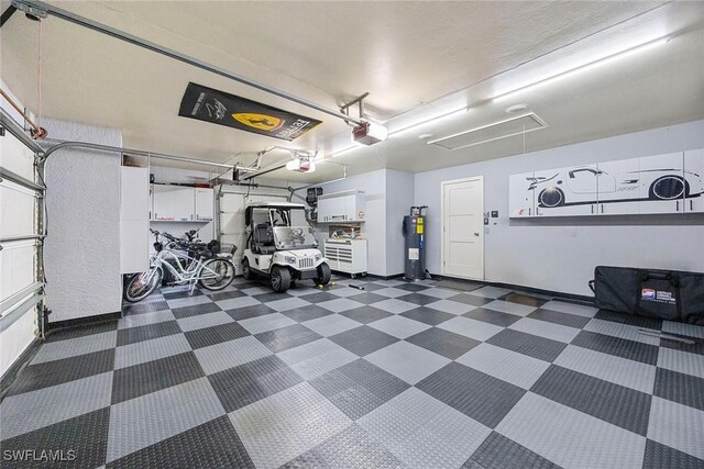 13461 Bridgeford Ave, Bonita Springs, FL 34135 - garage featuring water heater and a garage door opener