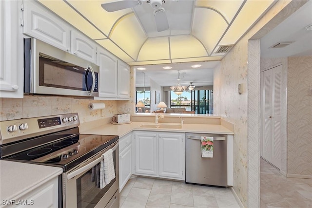 591 Seaview Ct Unit A306, Marco Island, FL 34145 - kitchen featuring stainless steel appliances, a ceiling fan, a sink, light countertops, and white cabinets