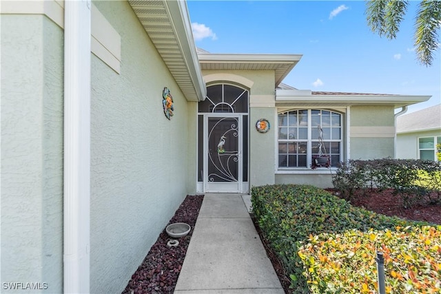 15721 Beachcomber Ave, Fort Myers, FL 33908 - view of exterior entry featuring stucco siding
