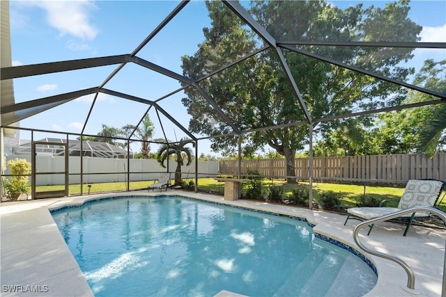 15721 Beachcomber Ave, Fort Myers, FL 33908 - view of swimming pool featuring a fenced backyard, a patio area, and glass enclosure