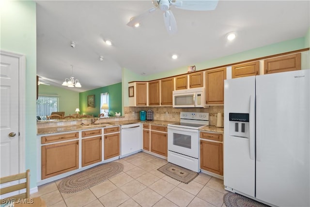 15721 Beachcomber Ave, Fort Myers, FL 33908 - kitchen with white appliances, backsplash, lofted ceiling, light tile patterned floors, and a chandelier