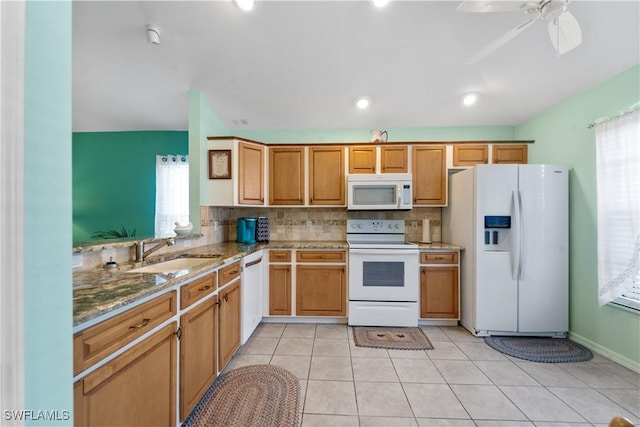 15721 Beachcomber Ave, Fort Myers, FL 33908 - kitchen with white appliances, a sink, backsplash, light stone counters, and a ceiling fan