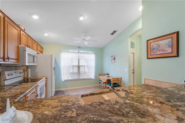 15721 Beachcomber Ave, Fort Myers, FL 33908 - kitchen featuring white appliances, a sink, arched walkways, a ceiling fan, and vaulted ceiling