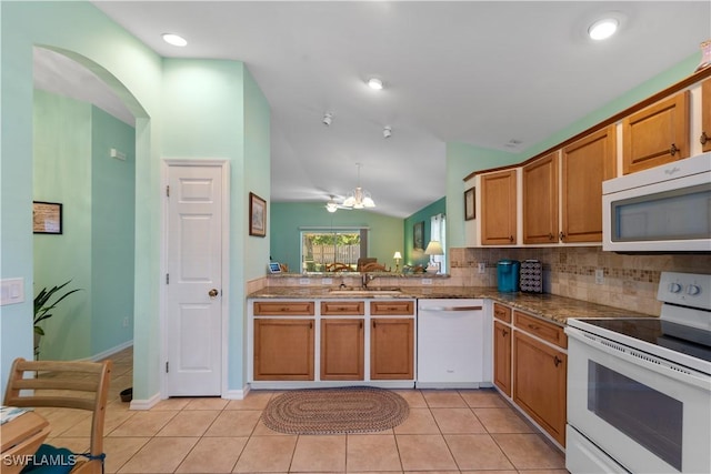 15721 Beachcomber Ave, Fort Myers, FL 33908 - kitchen featuring white appliances, a sink, lofted ceiling, tasteful backsplash, and light tile patterned flooring
