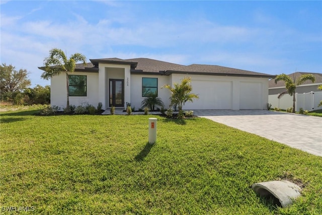 2204 SW 3rd Ter, Cape Coral, FL 33991 - prairie-style home with an attached garage, decorative driveway, a front lawn, and stucco siding