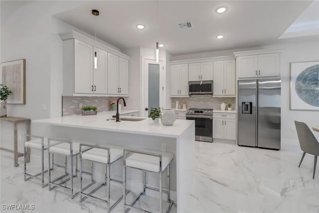2204 SW 3rd Ter, Cape Coral, FL 33991 - kitchen featuring stainless steel appliances, a sink, light marble finish floors, a kitchen bar, and recessed lighting