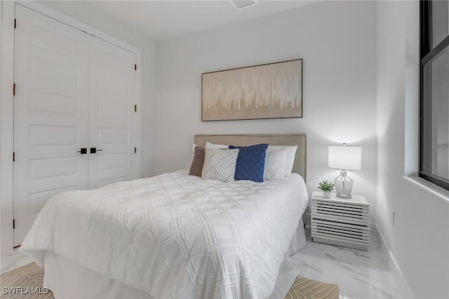 2204 SW 3rd Ter, Cape Coral, FL 33991 - bedroom featuring marble look tiles, baseboards, and a closet