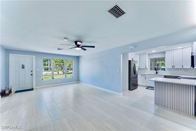 4101 Rainbow Dr, Fort Myers, FL 33916 - unfurnished living room with a sink, a ceiling fan, and baseboards