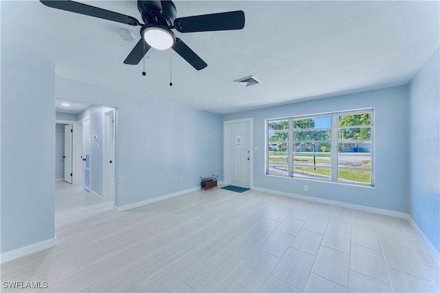 4101 Rainbow Dr, Fort Myers, FL 33916 - unfurnished living room with baseboards and ceiling fan