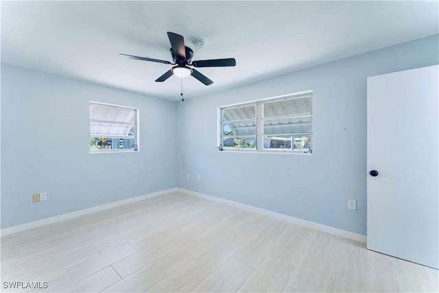 4101 Rainbow Dr, Fort Myers, FL 33916 - unfurnished room featuring healthy amount of natural light, a ceiling fan, and baseboards