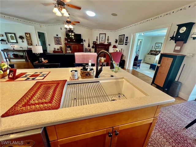40 Ortona St, Lehigh Acres, FL 33936 - kitchen featuring open floor plan, ceiling fan, vaulted ceiling, a sink, and a fireplace