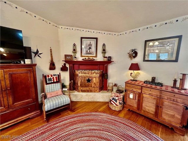 40 Ortona St, Lehigh Acres, FL 33936 - sitting room featuring wood finished floors and a premium fireplace