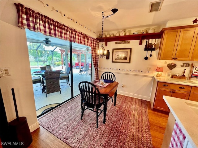 40 Ortona St, Lehigh Acres, FL 33936 - dining area with light wood-type flooring, a ceiling fan, and baseboards