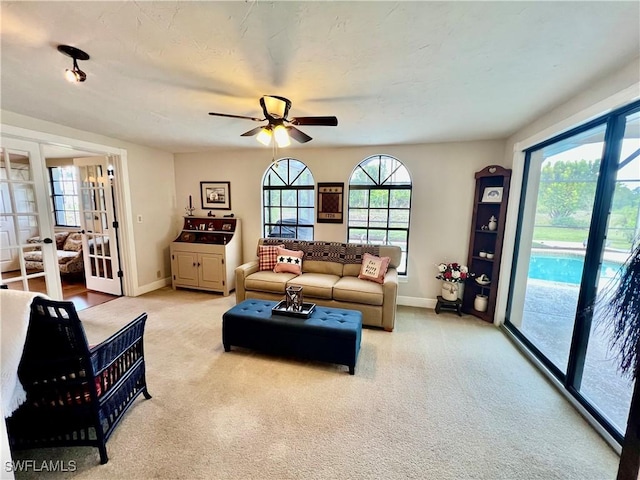 40 Ortona St, Lehigh Acres, FL 33936 - living area featuring ceiling fan, baseboards, french doors, and light colored carpet