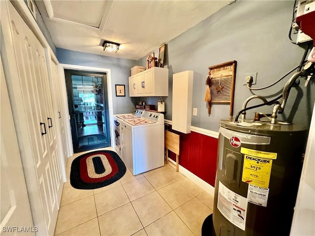 40 Ortona St, Lehigh Acres, FL 33936 - laundry area featuring electric water heater, cabinet space, washer and dryer, light tile patterned flooring, and baseboards