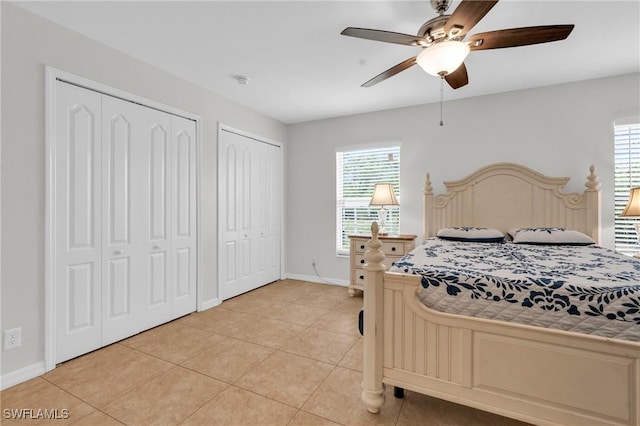 1402 Congress Ave, Lehigh Acres, FL 33972 - bedroom featuring two closets, light tile patterned flooring, baseboards, and ceiling fan