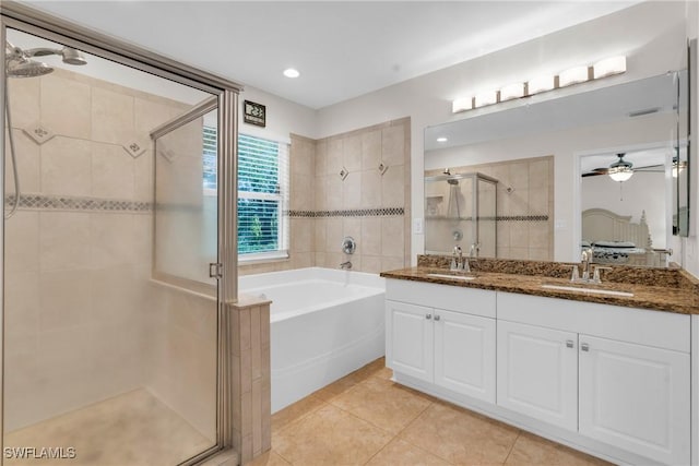 1402 Congress Ave, Lehigh Acres, FL 33972 - bathroom featuring a shower stall, a bath, double vanity, tile patterned flooring, and ceiling fan
