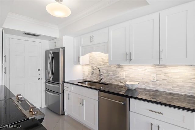 2600 Gulf Shore Blvd N Unit 54, Naples, FL 34103 - kitchen featuring stainless steel appliances, a sink, dark countertops, crown molding, and white cabinets