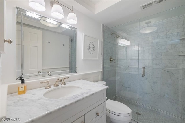 2600 Gulf Shore Blvd N Unit 54, Naples, FL 34103 - bathroom featuring vanity, a stall shower, and toilet