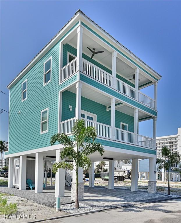 26275 Hickory Blvd Unit 26, Bonita Springs, FL 34134 - view of building exterior featuring a carport and driveway