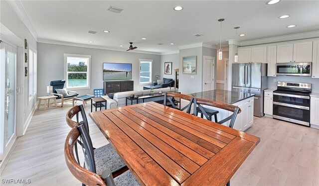 26275 Hickory Blvd Unit 26, Bonita Springs, FL 34134 - dining space with ornamental molding, recessed lighting, light wood-type flooring, and baseboards