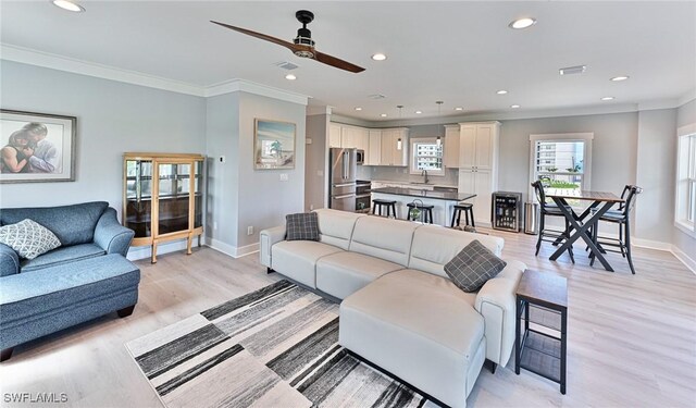 26275 Hickory Blvd Unit 26, Bonita Springs, FL 34134 - living area with crown molding, baseboards, recessed lighting, ceiling fan, and light wood-type flooring