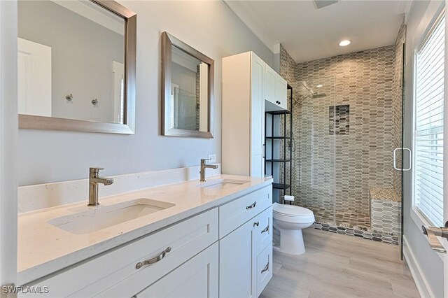 26275 Hickory Blvd Unit 26, Bonita Springs, FL 34134 - bathroom with toilet, double vanity, a stall shower, wood finished floors, and recessed lighting