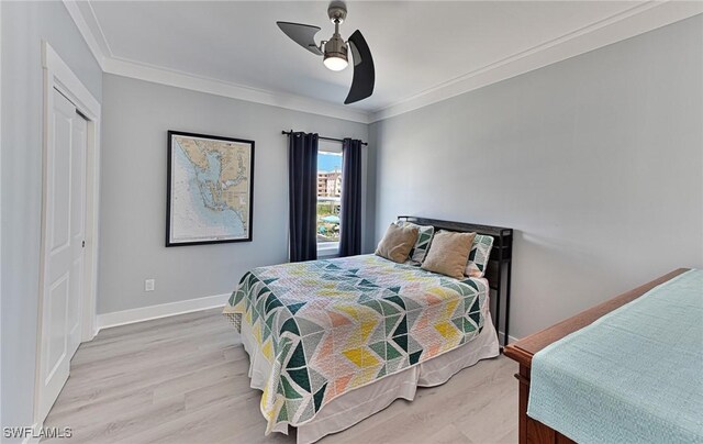 26275 Hickory Blvd Unit 26, Bonita Springs, FL 34134 - bedroom featuring wood finished floors, ornamental molding, a ceiling fan, a closet, and baseboards