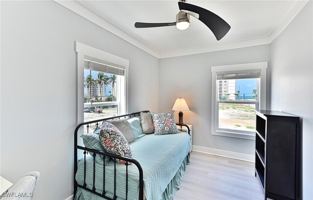26275 Hickory Blvd Unit 26, Bonita Springs, FL 34134 - bedroom with ornamental molding, light wood-type flooring, baseboards, and a ceiling fan