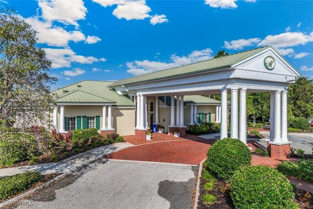 3659 Rollingwater Way N, Fort Myers, FL 33917 - view of front of property with metal roof, a porch, and a standing seam roof