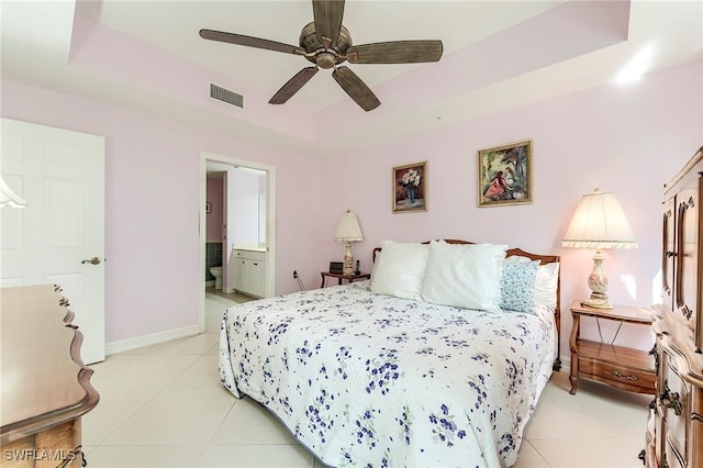 10800 Palazzo Way Unit 204, Fort Myers, FL 33913 - bedroom featuring light tile patterned floors, a raised ceiling, baseboards, and ensuite bath