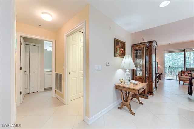 10800 Palazzo Way Unit 204, Fort Myers, FL 33913 - hallway with light tile patterned floors and baseboards