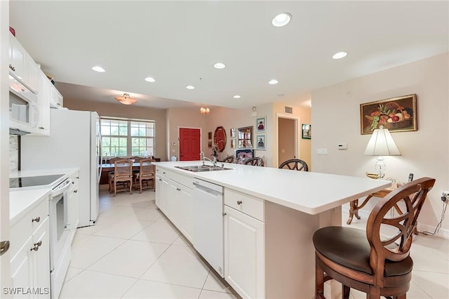 10800 Palazzo Way Unit 204, Fort Myers, FL 33913 - kitchen featuring white appliances, a sink, a kitchen bar, an island with sink, and light countertops