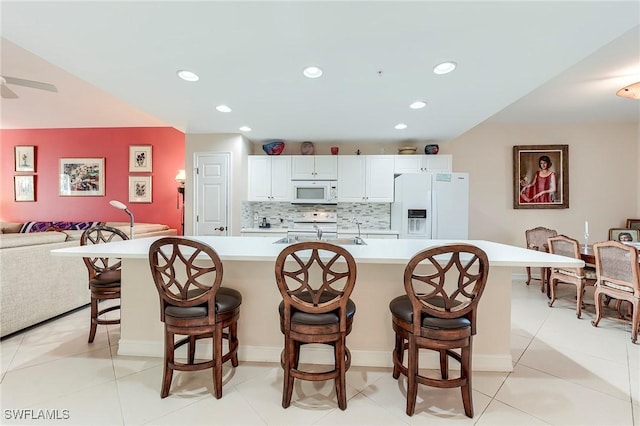 10800 Palazzo Way Unit 204, Fort Myers, FL 33913 - kitchen with white appliances, a sink, light countertops, tasteful backsplash, and recessed lighting