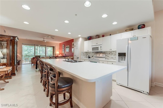 10800 Palazzo Way Unit 204, Fort Myers, FL 33913 - kitchen featuring white appliances, a sink, light countertops, recessed lighting, and a kitchen breakfast bar
