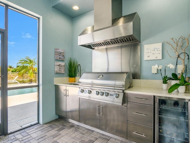 6478 Warwick Ave, Naples, FL 34113 - kitchen with wall chimney range hood, wine cooler, brick patterned flooring, and light countertops