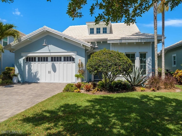 6478 Warwick Ave, Naples, FL 34113 - view of front facade with stucco siding, a front yard, a garage, and decorative driveway