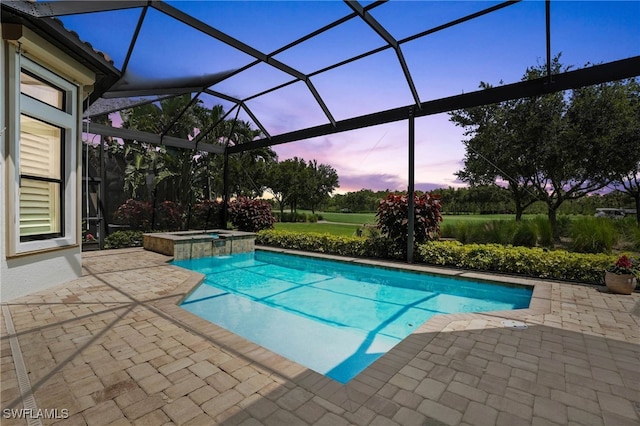 8836 Savona Ct, Naples, FL 34119 - pool at dusk featuring a patio area, a pool with connected hot tub, and glass enclosure