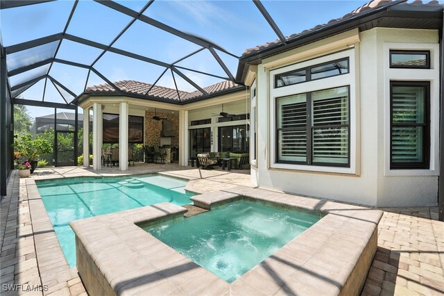 8836 Savona Ct, Naples, FL 34119 - view of pool with ceiling fan, a patio, a pool with connected hot tub, and glass enclosure