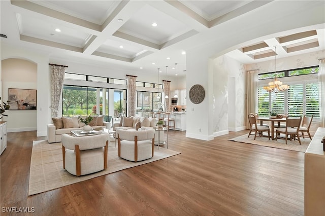 8836 Savona Ct, Naples, FL 34119 - living area featuring arched walkways, coffered ceiling, wood finished floors, a chandelier, and beamed ceiling