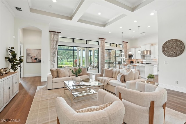 8836 Savona Ct, Naples, FL 34119 - living room featuring recessed lighting, light wood-style floors, beamed ceiling, coffered ceiling, and arched walkways
