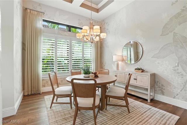 8836 Savona Ct, Naples, FL 34119 - dining space featuring wallpapered walls, wood finished floors, and a chandelier