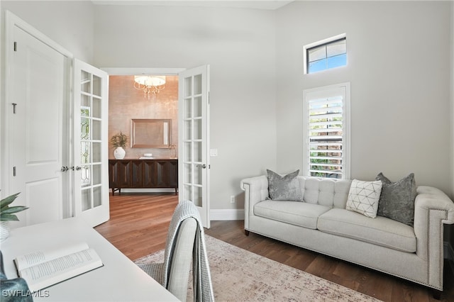 8836 Savona Ct, Naples, FL 34119 - office with french doors, a chandelier, wood finished floors, and a high ceiling