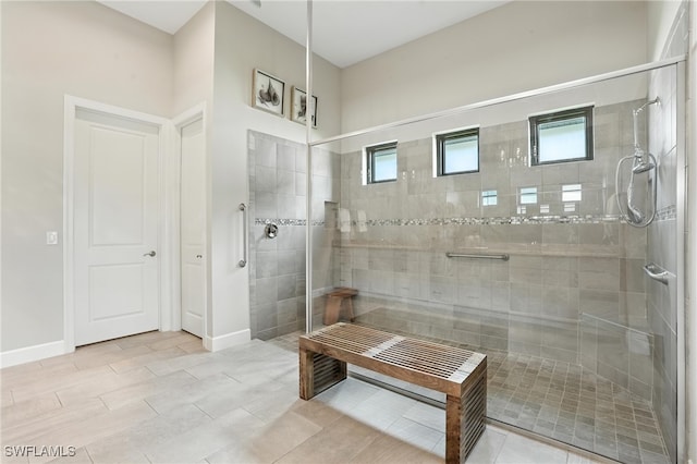 8836 Savona Ct, Naples, FL 34119 - bathroom featuring a tile shower and baseboards