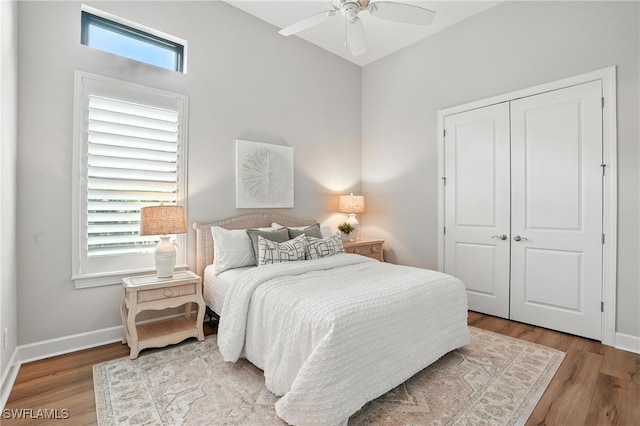 8836 Savona Ct, Naples, FL 34119 - bedroom with wood finished floors, a closet, and a ceiling fan