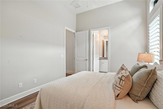 8836 Savona Ct, Naples, FL 34119 - bedroom with wood finished floors and connected bathroom