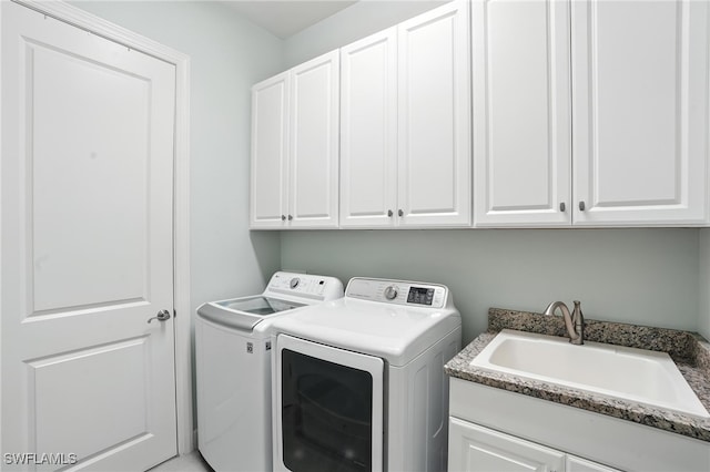 8836 Savona Ct, Naples, FL 34119 - washroom with washing machine and clothes dryer and cabinet space