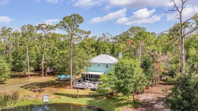 20433 Fern Cir, North Fort Myers, FL 33917 - back of property with a wooded view